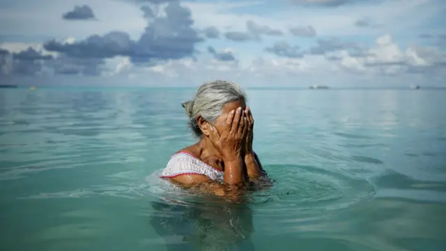 Suega Apelu stands in the lagoon on November 28, 2019 in Funafuti, Tuvalu.