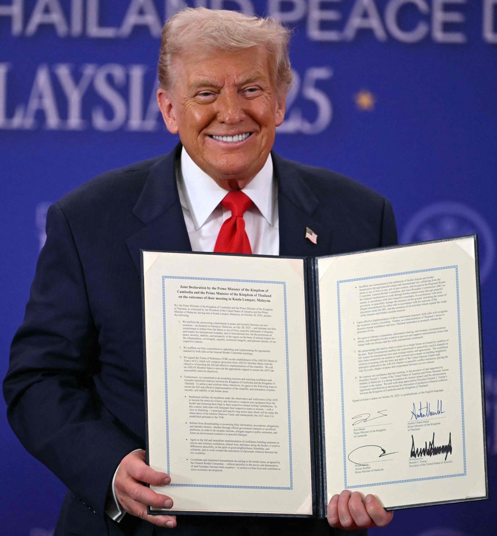 US President Donald Trump holds a signed document during the ceremonial signing of a ceasefire agreement between Cambodia and Thailand on Sunday. Photo: AFP US President Donald Trump holds a signed document during the ceremonial signing of a ceasefire agreement between Cambodia and Thailand on Sunday. Photo: AFP