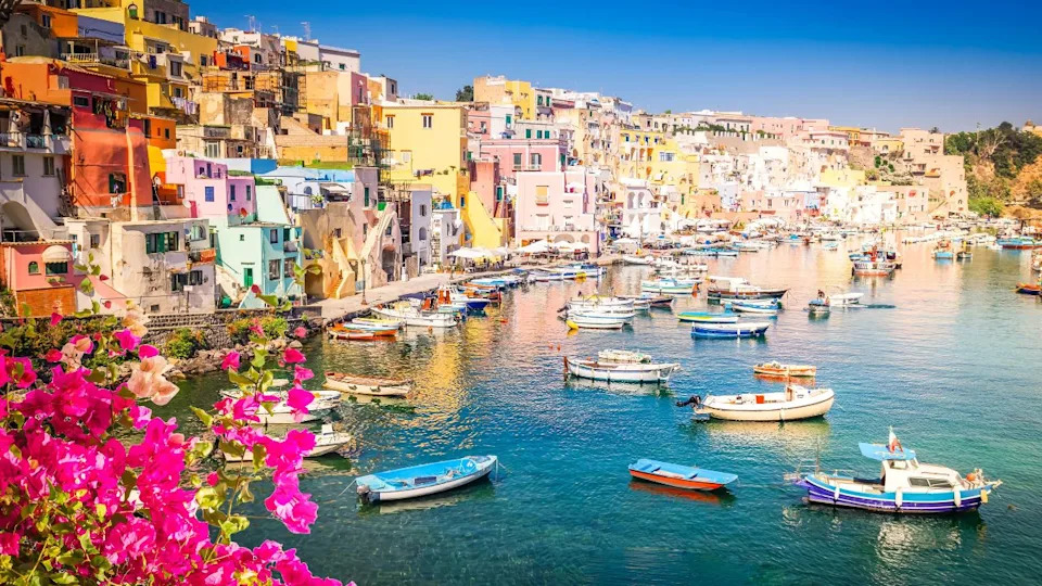 Procida island colorful town with harbor at summer with flowers, Italy