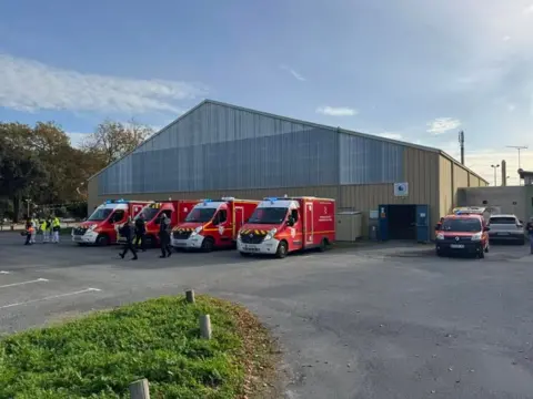 Thibault Brechkoff Firefighting lorries outside a building