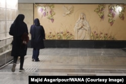 Iranian women walk through a corridor of the Holy Virgin Mary station during a preview of the facility for the press on October 18.