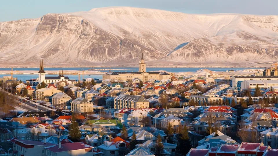 Elevated view over the churches and city, with a backdrop of snow capped mountains, reykjavik, iceland, polar regions