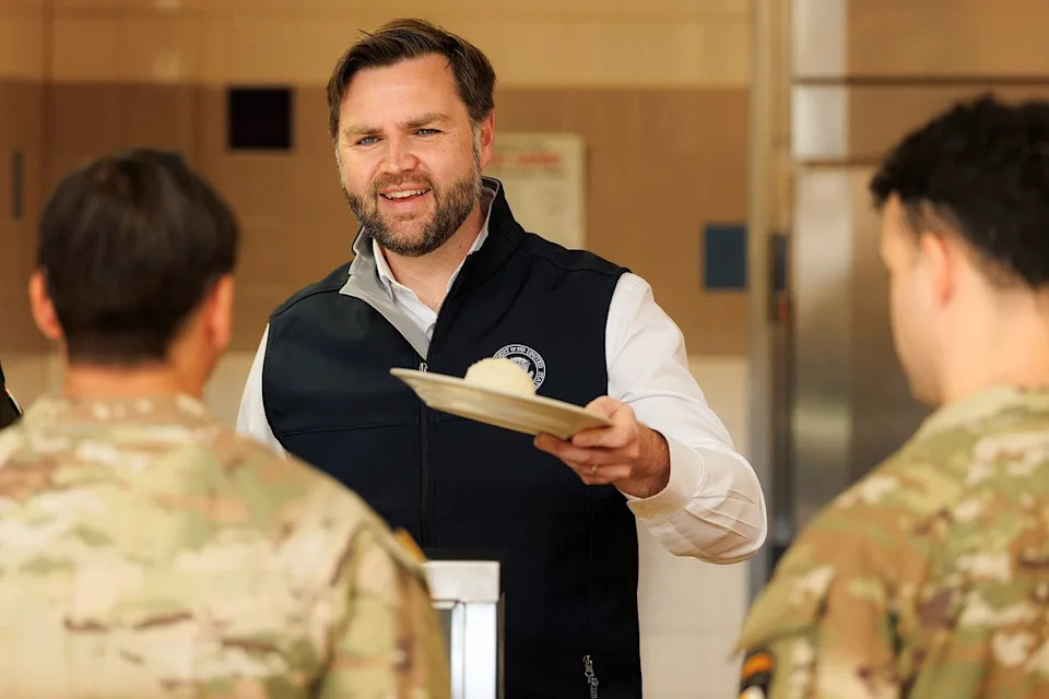 Brett Carlsen/Getty  JD Vance serves a Thanksgiving meal to members of the U.S. military