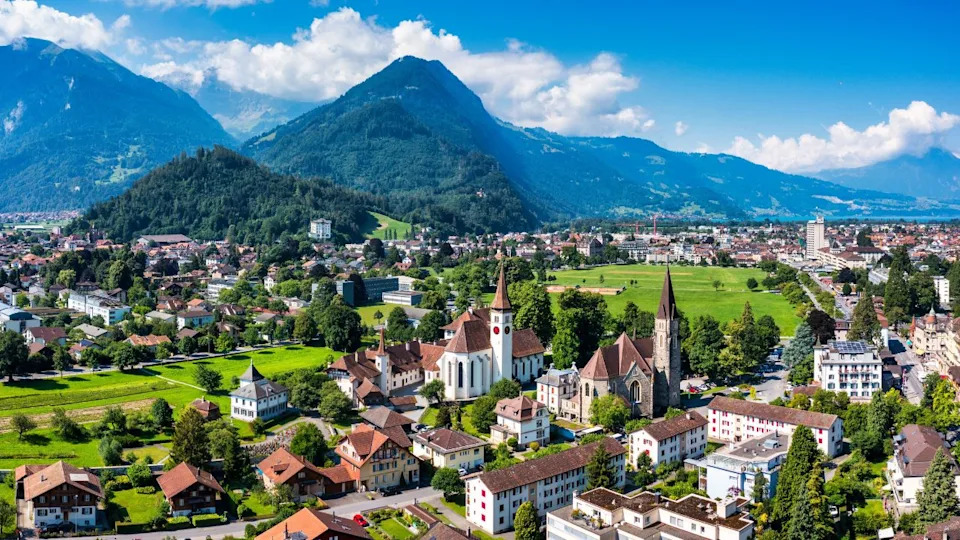 Aerial view over the city of Interlaken in Switzerland. Beautiful view of Interlaken town, Eiger, Monch and Jungfrau mountains and of Lake Thun and Brienz. Interlaken, Bernese Oberland, Switzerland.