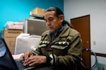 Alex Llumiquinga, the executive director of Arcoíris Cultural, works on a letter appealing a recent local Immigration and Customs Enforcement detainment at his office on Nov. 17, 2025, in Newport, Ore. 