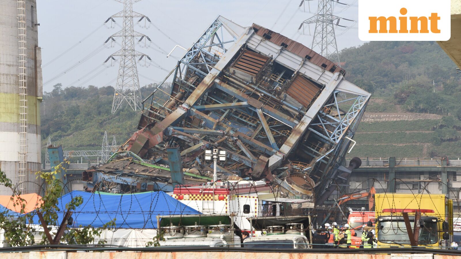 Rescue team work near a 60-meter (196-foot) tower which collapsed during demolition work at a decommissioned thermal power plant in Ulsan, South Korea