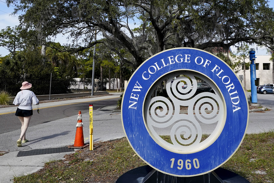 FILE - A student makes her way past the sign at New College of Florida, Jan. 20, 2023, in Sarasota, Fla. (AP Photo/Chris O'Meara, File)