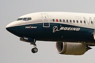 FILE - A Boeing 737 Max jet prepares to land at Boeing Field following a test flight in...