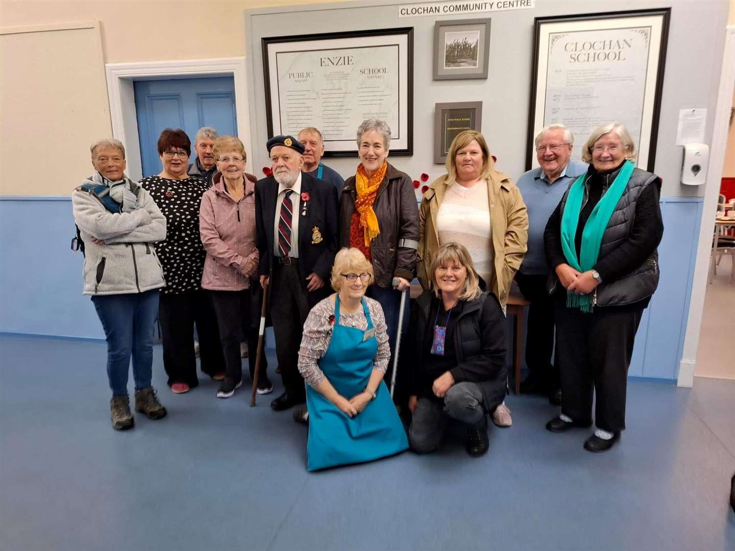 Allan Fraser (middle row, third left) is joined by CCC chairwoman Christine Kennedy (front left) and other members of the community centre team at the new memorial. Picture: CCC
