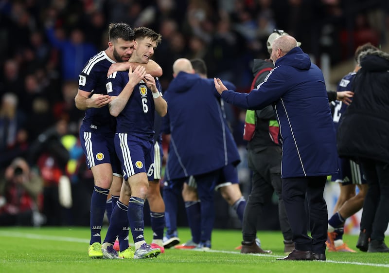 Kieran Tierney (6) of Scotland celebrates scoring his team's third goal with head coach Steve Clarke in Glasgow last night. Photo: Ian MacNicol/Getty Images