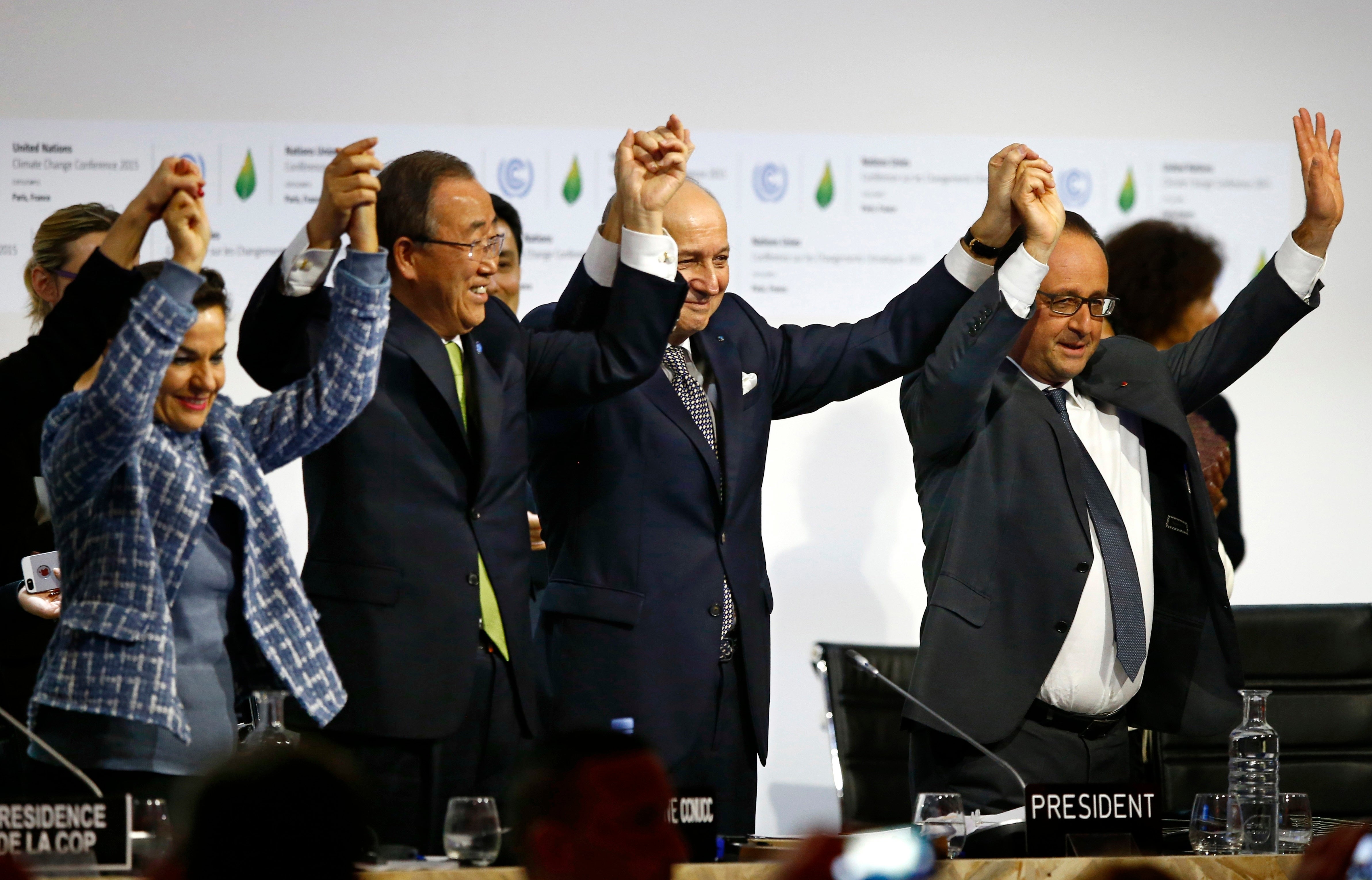 Christiana Figueres, left, former UN secretary general Ban Ki-moon and former French president Francois Hollande, right, celebrate the Paris Agreement at Cop21 in Paris in 2015