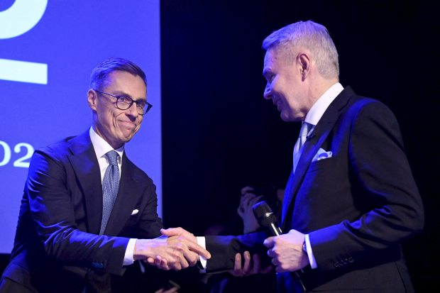 Newly elected Finnish President Alexander Stubb, left, shakes hands with Green Party-backed candidate Pekka Haavisto at his election reception in Helsinki, Finland, on Feb. 11, 2024. (Vesa Moilanen/Lehtikuva)