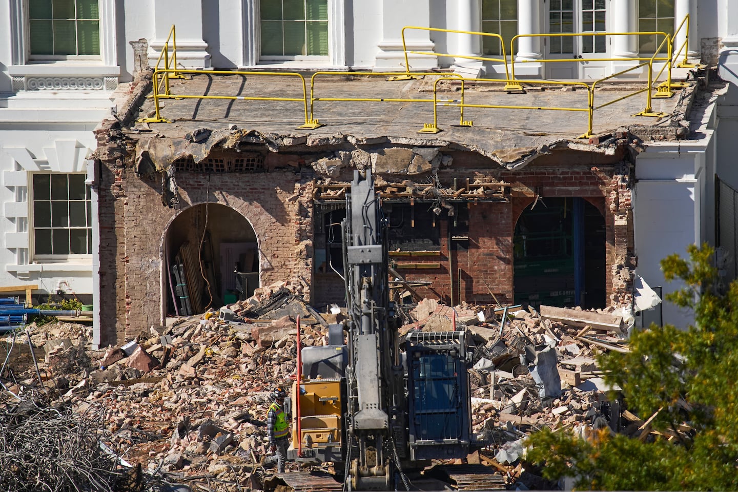 A worker walked among debris from a largely demolished part of the East Wing of the White House. President Trump has raised money from private donors to pay for the work, raising worries about potential conflicts of interest.