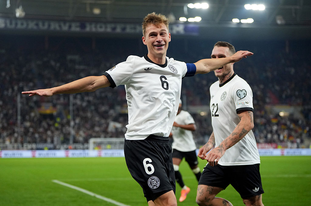 SINSHEIM, GERMANY - OCTOBER 10: Joshua Kimmich of Germany celebrates scoring his team's fourth goal with teammate David Raum during the FIFA World Cup 2026 Qualifier match between Germany and Luxembourg at PreZero-Arena on October 10, 2025 in Sinsheim, Germany. (Photo by Pau Barrena/Getty Images)