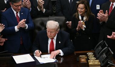 President Donald Trump signs a spending package to reopen the federal government in the Oval Office at the White House on Wednesday night. (Brendan Smialowski/AFP via Getty Images)