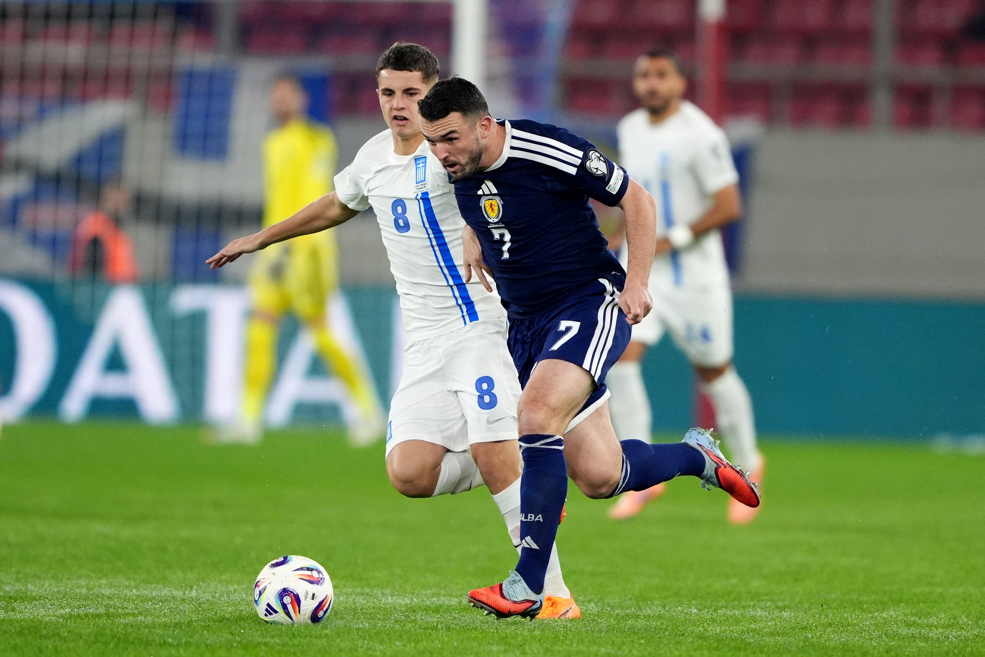 Greece's Christos Mouzakitis (left) and Scotland's John McGinn battle for the ball