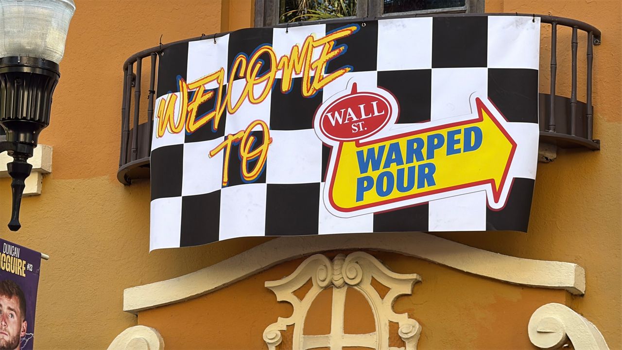 Warped tour sign at Wall Street Plaza