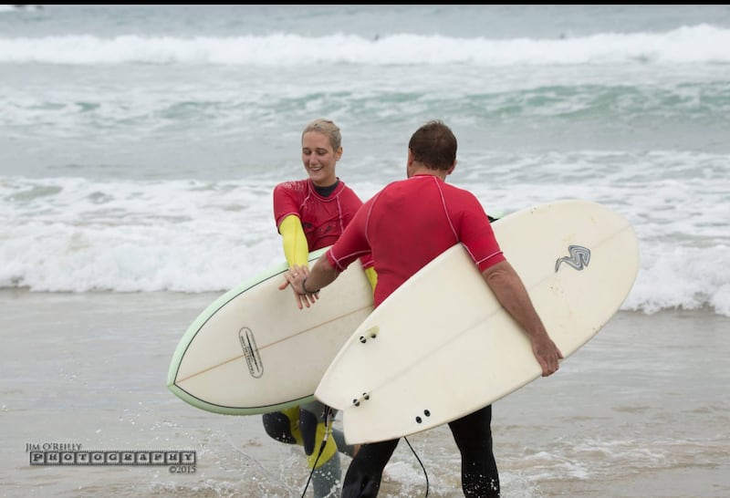Surfers high five during the tag team event of the 2015 Coffs Soul Surfest in Coffs Harbour, Australia, September 2015.