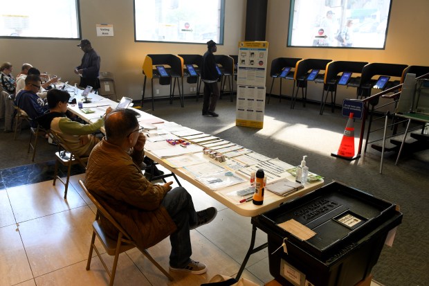 Voters fills out their ballots at the Millennium Biltmore Tower...