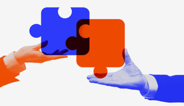 Colorful collage. Hands holding orange and blue puzzle pieces representing corporate merger. Concept of digital transformation, strategic integration, teamwork, and business process design.