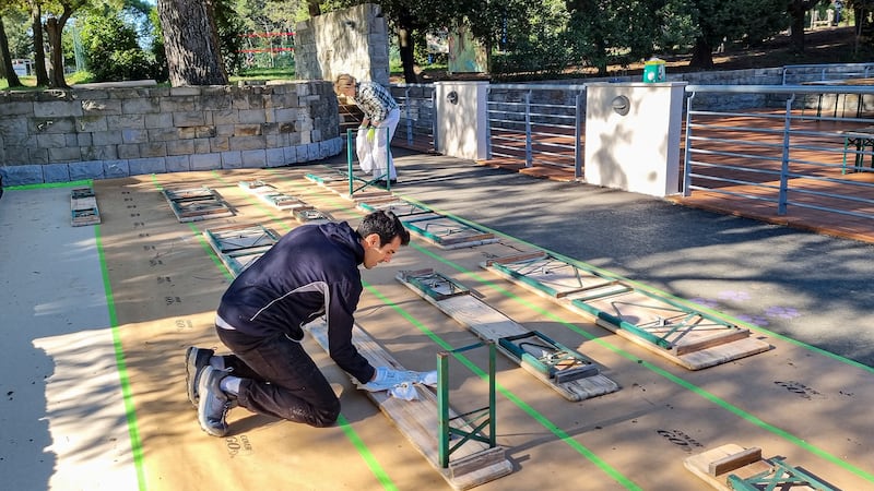 Davide Lotito clean benches at the Debeli Rtič Health Resort on the Adriatic Sea in Slovenia on Friday, Nov. 7, 2025.