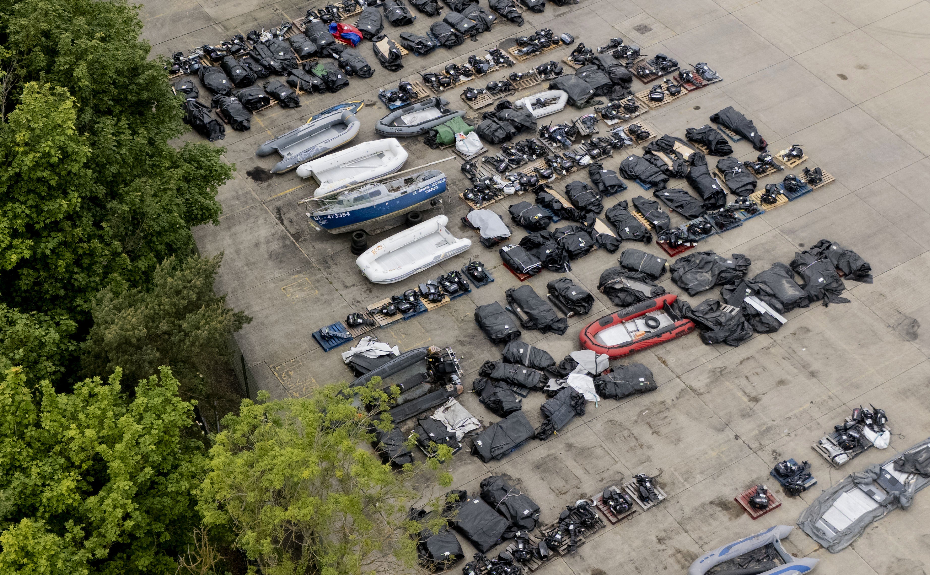 A view of small boats and outboard motors used by people thought to be migrants to cross the Channel from France at a warehouse facility in Dover, Kent. Small boat arrivals are up 53 per cent year on year.