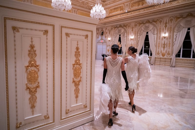 Dancers walk through an event hall at Mar-a-Lago during Trump's Gatsby-themed Halloween bash.