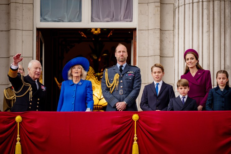 Royal Family members waving from balcony during public appearance at historical event in London