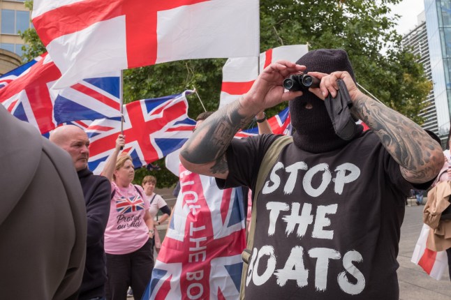 NEWCASTLE UPON TYNE, ENGLAND - SEPTEMBER 06: Demonstrators gather during an anti-immigration protest outside the New Bridge Hotel in Newcastle on September 06, 2025 in Newcastle upon Tyne, England. Far right protests have been taking place across the country over the summer weeks outside hotels housing migrants, following an accusation of sexual assault against an asylum seeker staying at the Bell Hotel in Epping. (Photo by Ian Forsyth/Getty Images)