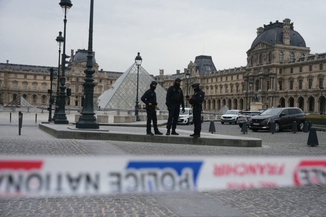 French police officers patrol in front of the Louvre Museum after it was robbed, with the Louvre Pyramid designed by Ieoh Ming Pei in the background, in Paris on October 19, 2025. Robbers broke in to the Louvre and fled with jewellery on October 19, 2025 morning, a source close to the case said, adding that its value was still being evaluated. A police source said an unknown number of thieves arrived on a scooter armed with small chainsaws and used a goods lift to reach the room they were targeting. (Photo by Dimitar DILKOFF / AFP) / RESTRICTED TO EDITORIAL USE - MANDATORY MENTION OF THE ARTIST UPON PUBLICATION - TO ILLUSTRATE THE EVENT AS SPECIFIED IN THE CAPTION (Photo by DIMITAR DILKOFF/AFP via Getty Images)
