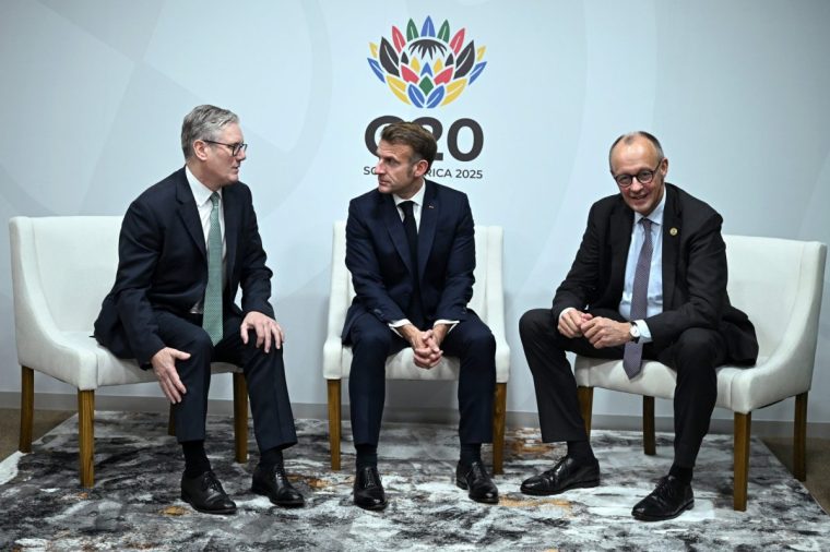 JOHANNESBURG, SOUTH AFRICA - NOVEMBER 22: Britain's Prime Minister Keir Starmer (L), France's President Emmanuel Macron (C) and German Chancellor Friedrich Merz (R) pose for a photograph during a trilateral meeting at the G20 Summit on November 22, 2025 in Johannesburg, South Africa ahead of the G20 Summit. The heads of state and government gathered here did not include those from the United States, which boycotted the event over its objections to South Africa???s G20 presidency. (Photo by Leon Neal/Getty Images)