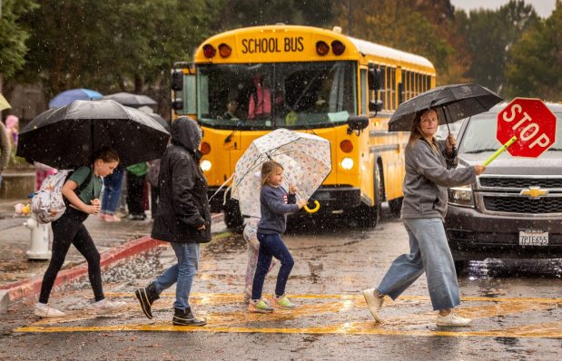 Rain falls during pickup time at Strawberry Elementary School in Santa Rosa on Oct. 13, 2025. Santa Rosa received 125% of its normal rainfall for the month of October. (John Burgess / The Press Democrat)