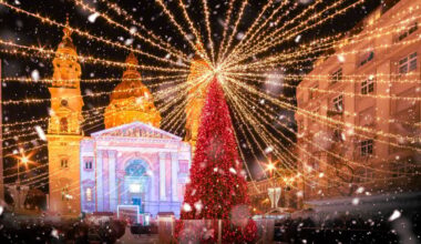 Christmas market at Saint Stephen Basilica on snowy night in Budapest