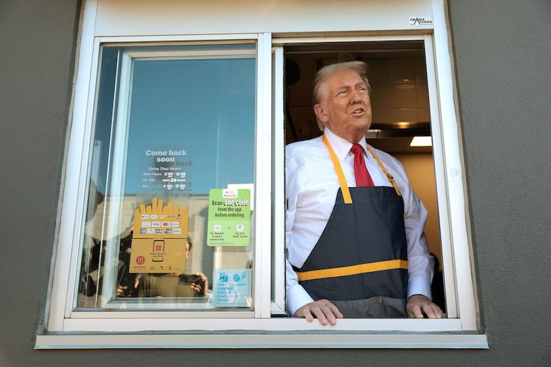 Republican presidential nominee, former U.S. President Donald Trump works the drive-through line during a campaign photo op as he visits a McDonald's restaurant on October 20, 2024 in Feasterville-Trevose, Pennsylvania.