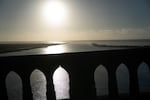 The sun begins to set over the Pacific on the Yaquina Bay Bridge in Newport, Ore., on Nov. 17, 2025.