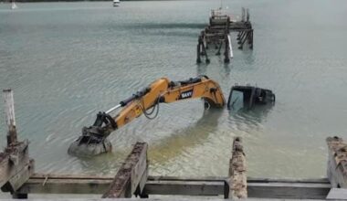 The little yellow digger that... went for a swim at Waitaria Bay jetty