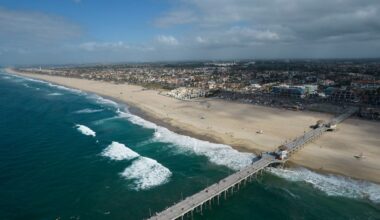 This aerial photo shows a reopened beach in Huntington Beach, Calif., Monday, Oct. 11, 2021. (AP Photo/Ringo H.W. Chiu)