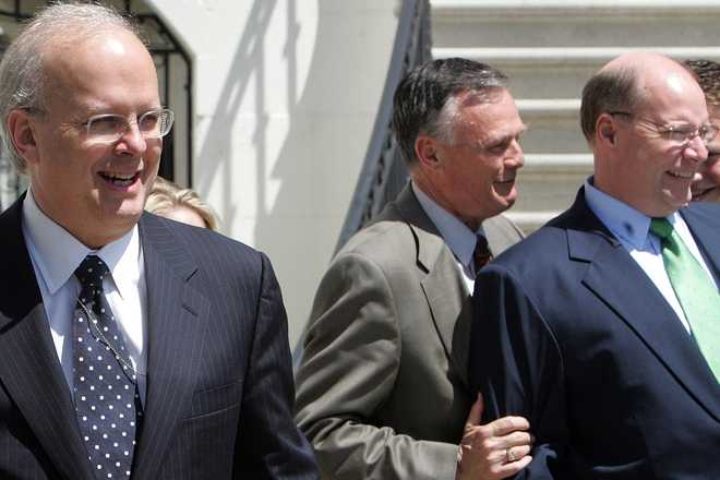 FILE - White House Deputy Chief of Staff Karl Rove, left, along with White House Chief Usher Gary Walters, center, and Deputy Chief of Staff Joseph Hagin, right , watch as President Bush departs the White House in Washington in this April 18, 2006 file photo. (AP Photo/Ron Edmonds, File)