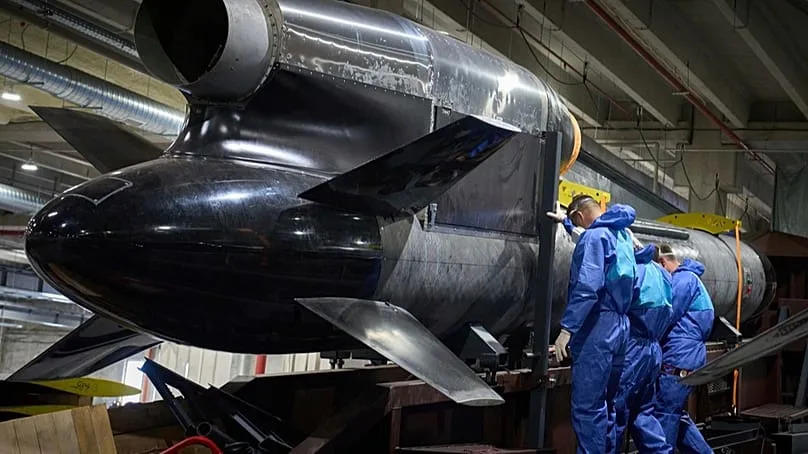 Workers in front of a Flamingo cruise missile at the Fire Point factory in Ukraine, 18 August 2025