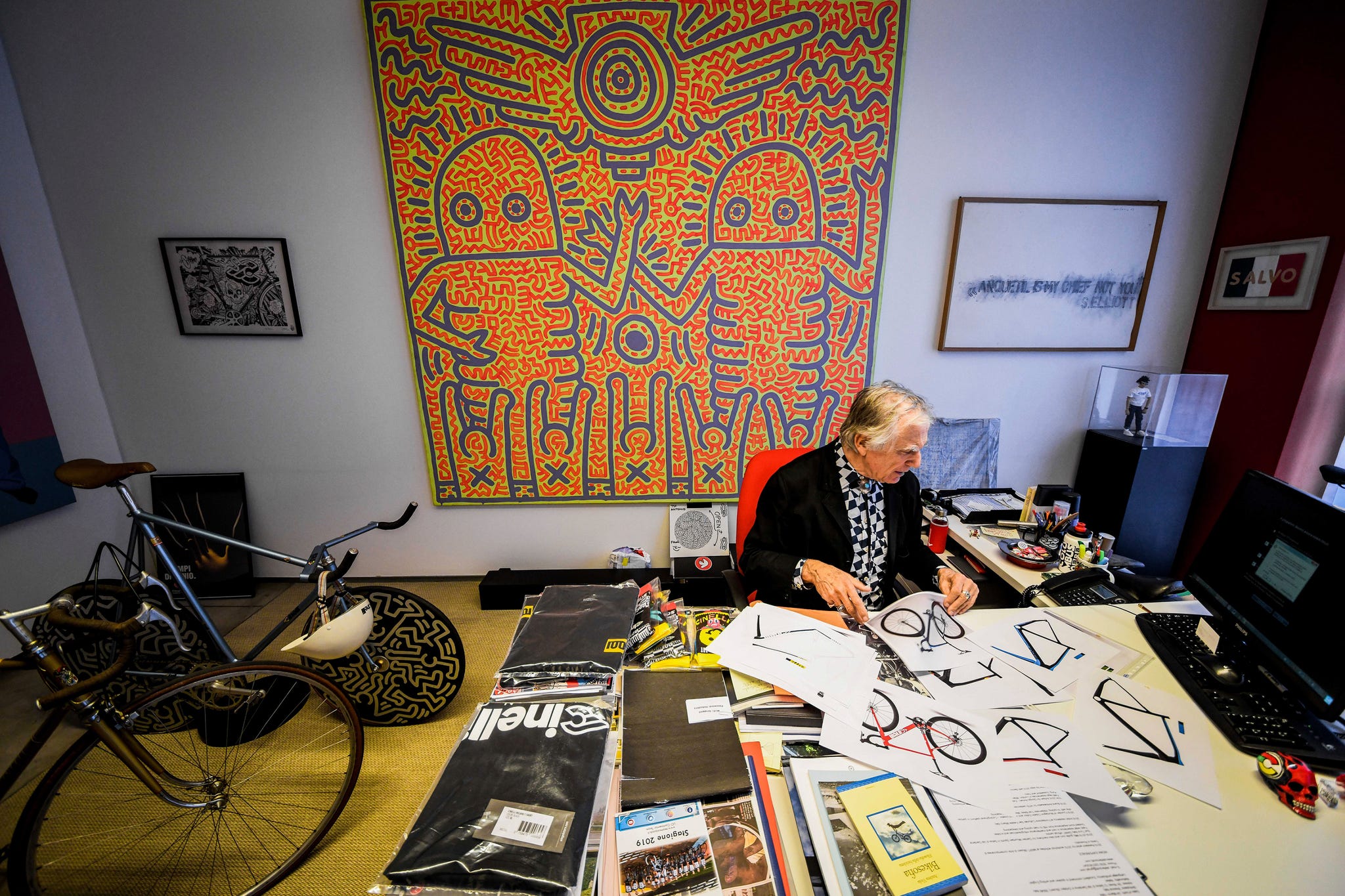 Office workspace with artistic elements and a bicycle.