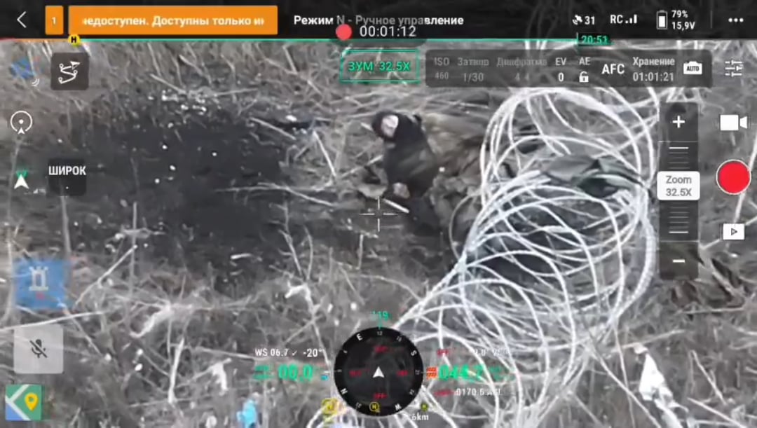 A Ukrainian FPV drone awaits the surrender of a russian soldier tangled up in barbed wire, he flips the drone off twice instead, upon which it engages him. November 2025.