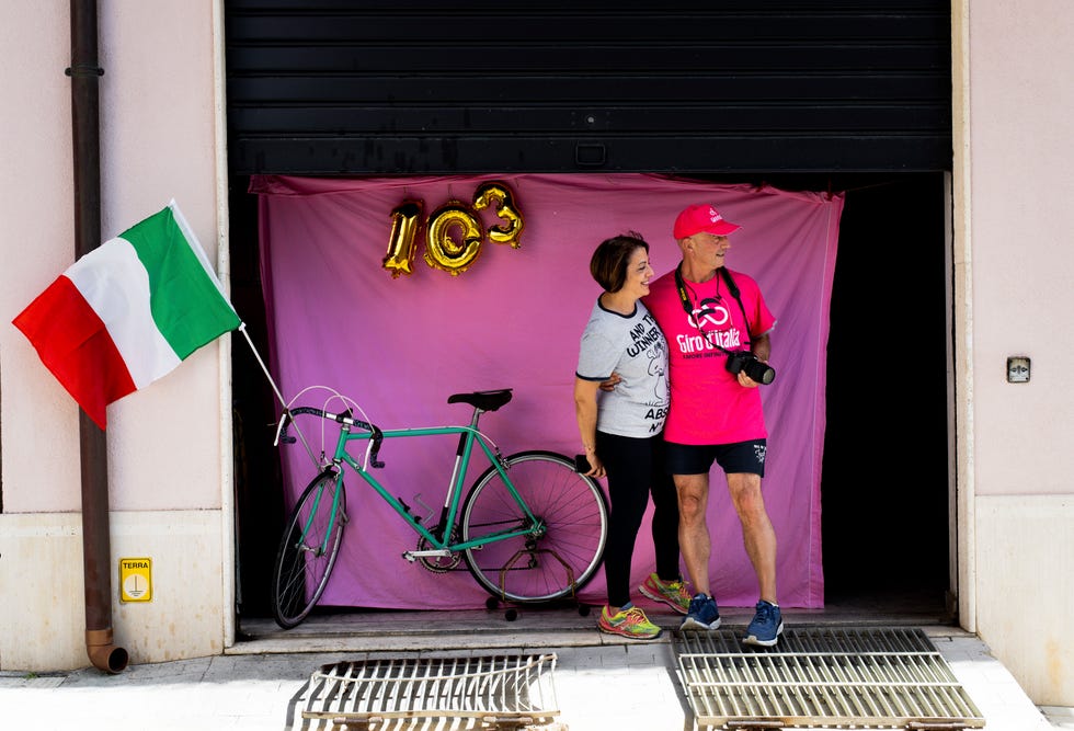 couple standing together outside awaiting the arrival of the peloton