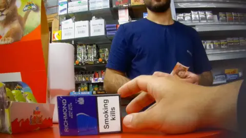 Undercover footage which captures a customer buying illegal cigarettes.  
