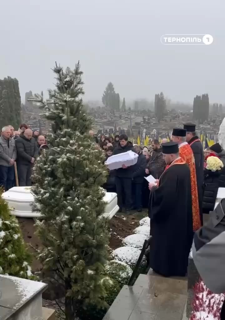 The father of one of the children killed in Ternopil rocks their coffin before burial. He lost his wife and both children in the attack - November 2025