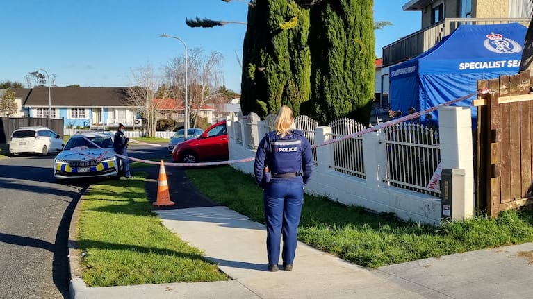 Police in Clendon Park, Auckland, following the discovery of human remains in a suitcase.
