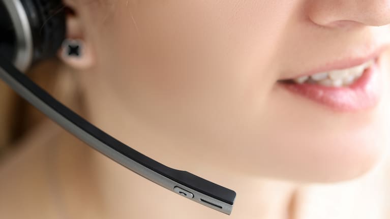 A person speaking on a headset.