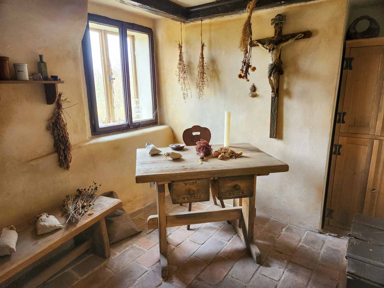 View of a room with drying herbs and flowers inside one of the buildings on Golden Lane inside the Prague Castle complex, one of the best places to visit in Prague with kids