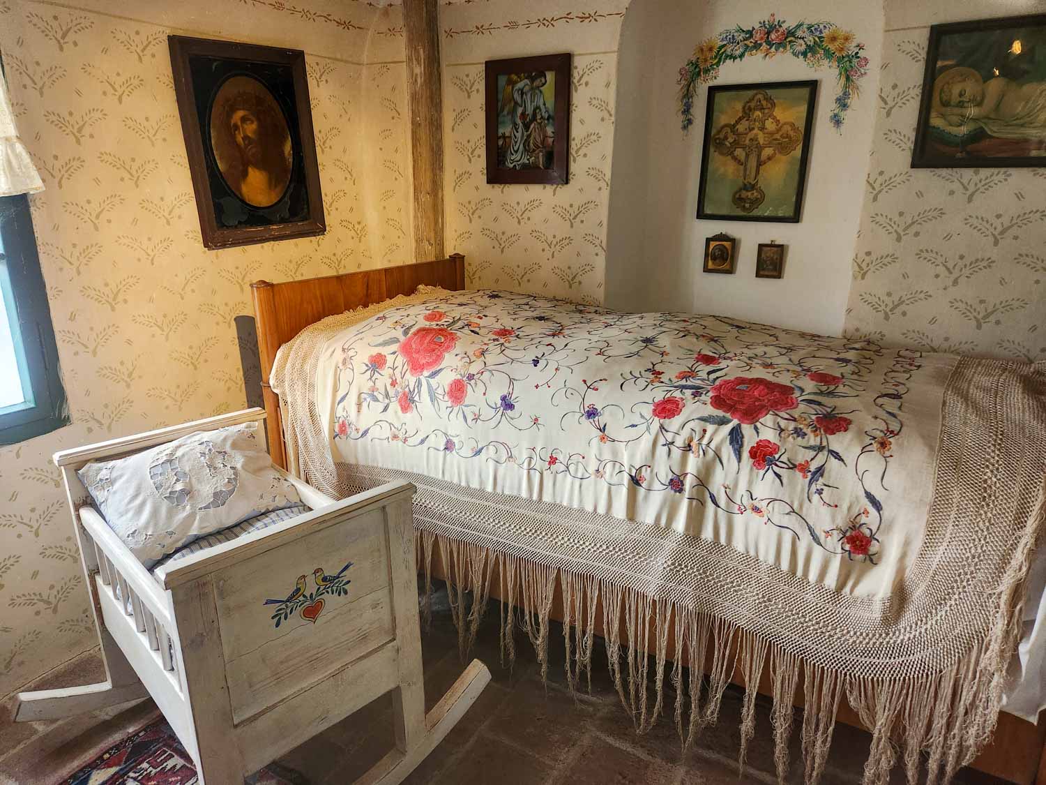 View of a bedroom with cot inside one of the buildings on Golden Lane inside the Prague Castle complex, one of the best places to visit in Prague with kids