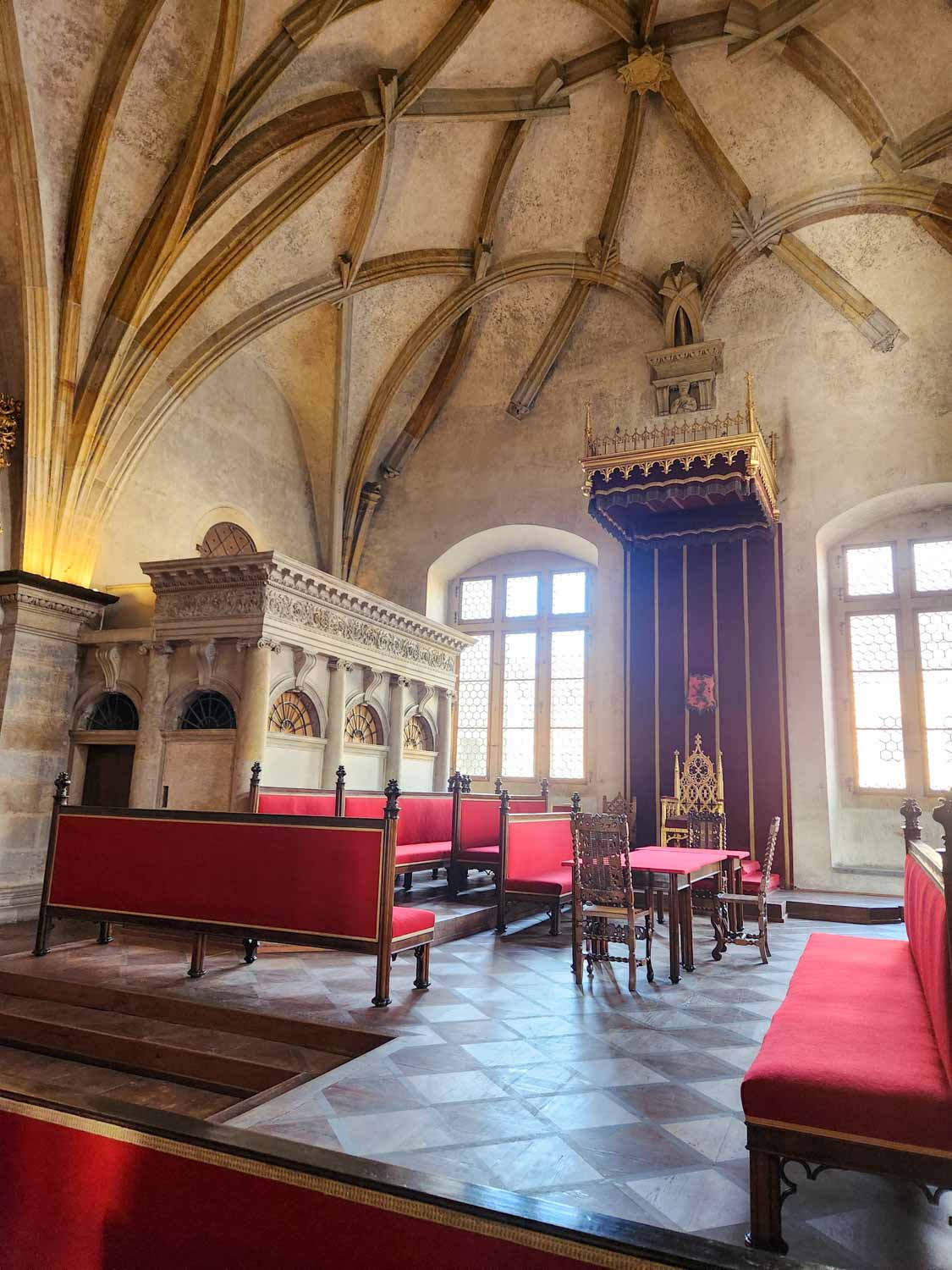 View of the Diet room in the old royal palace at Prague castle, where council members would meet and with a throne under a canopy