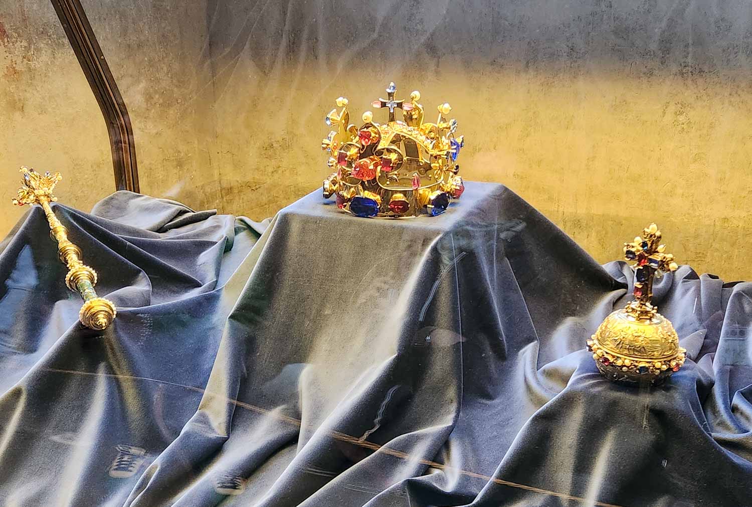 Replica crown jewels on display in the old royal palace at Prague castle, with crown, orb and sceptre
